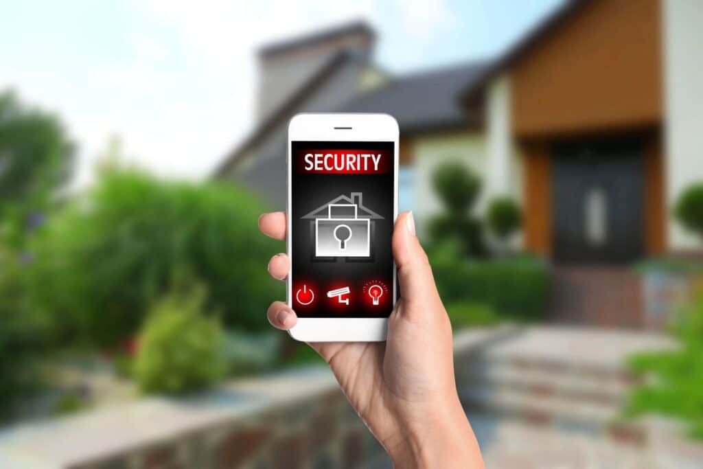 woman holding phone with security alert on screen