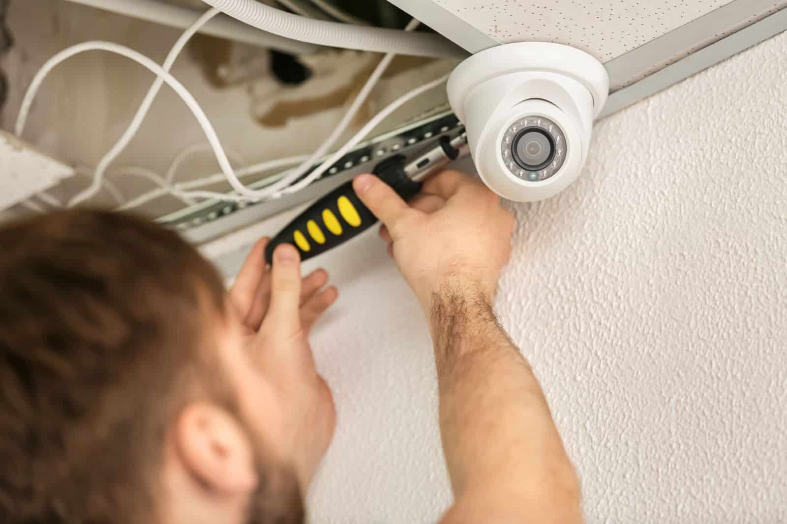 person installing security cameras Benalla